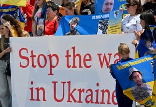 Relatives and friends of Ukrainian prisoners of war hold portraits of them during rally named