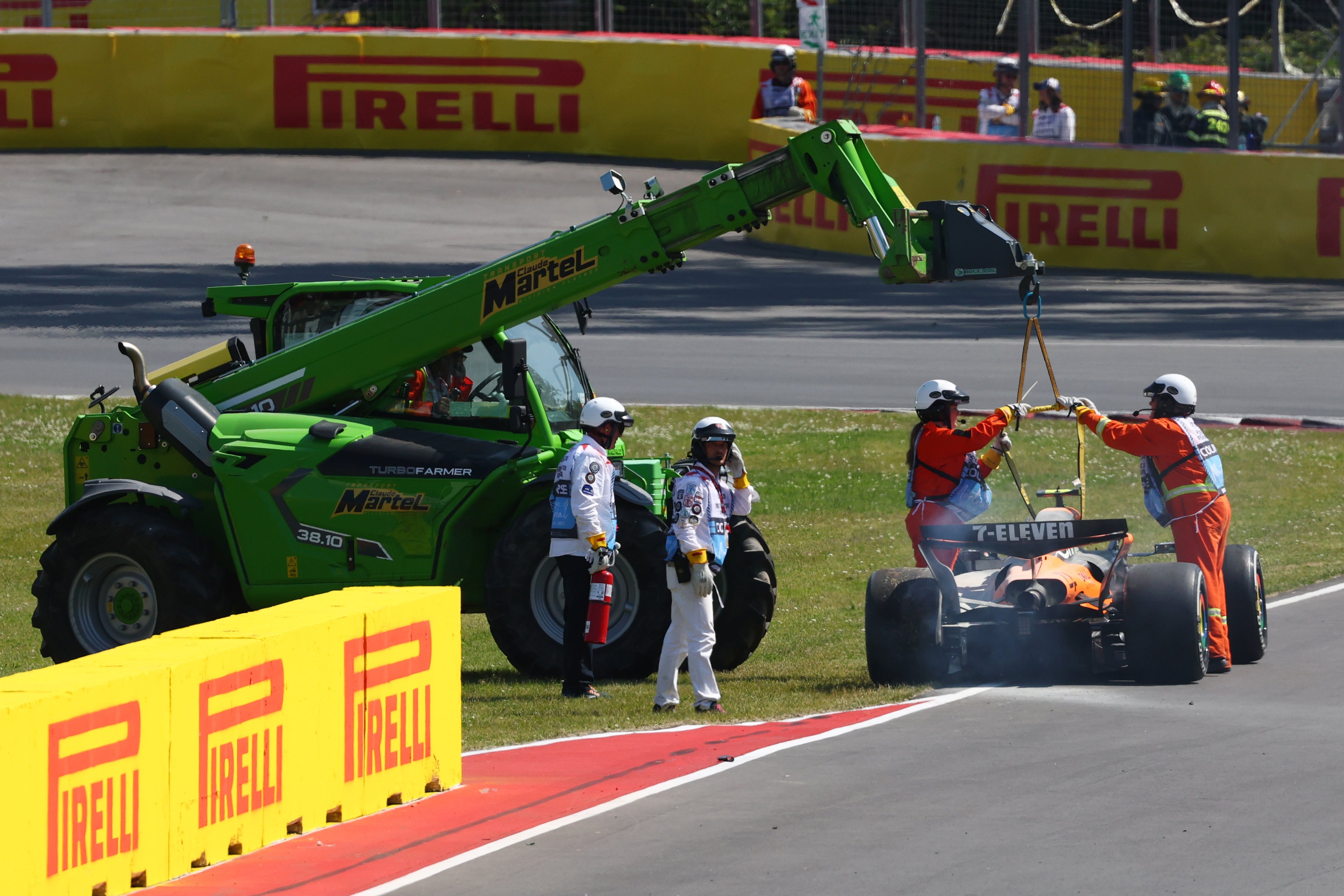 Marshals recover the damaged car of Lando Norris of Great Britain and McLaren after a crash during the F1 Grand Prix of Canada at Circuit Gilles-Villeneuve