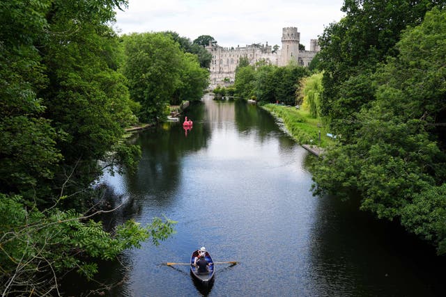 People use boats on the river Avon by Warwick Castle (Jacob King/PA)