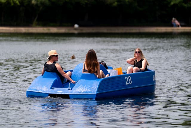<p>People on a pedalo in Hyde Park, London. Forecasters are expecting temperatures to climb to a peak of 33C on Sunday in the east of England</p>