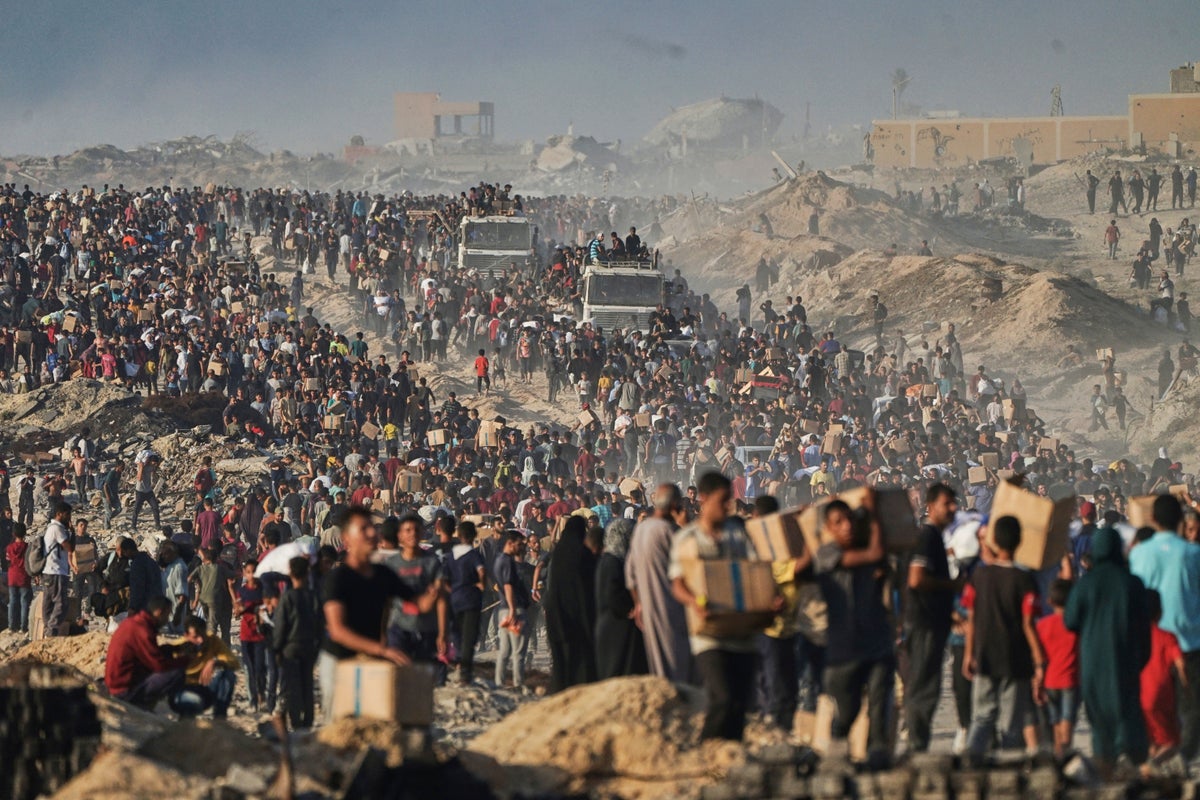 Photos show crowds of desperate Palestinians struggling to get food
