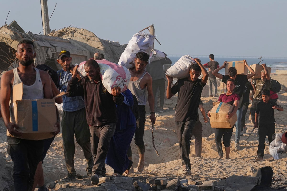 At least 59 Palestinians die as Israelis accused of shelling at aid site