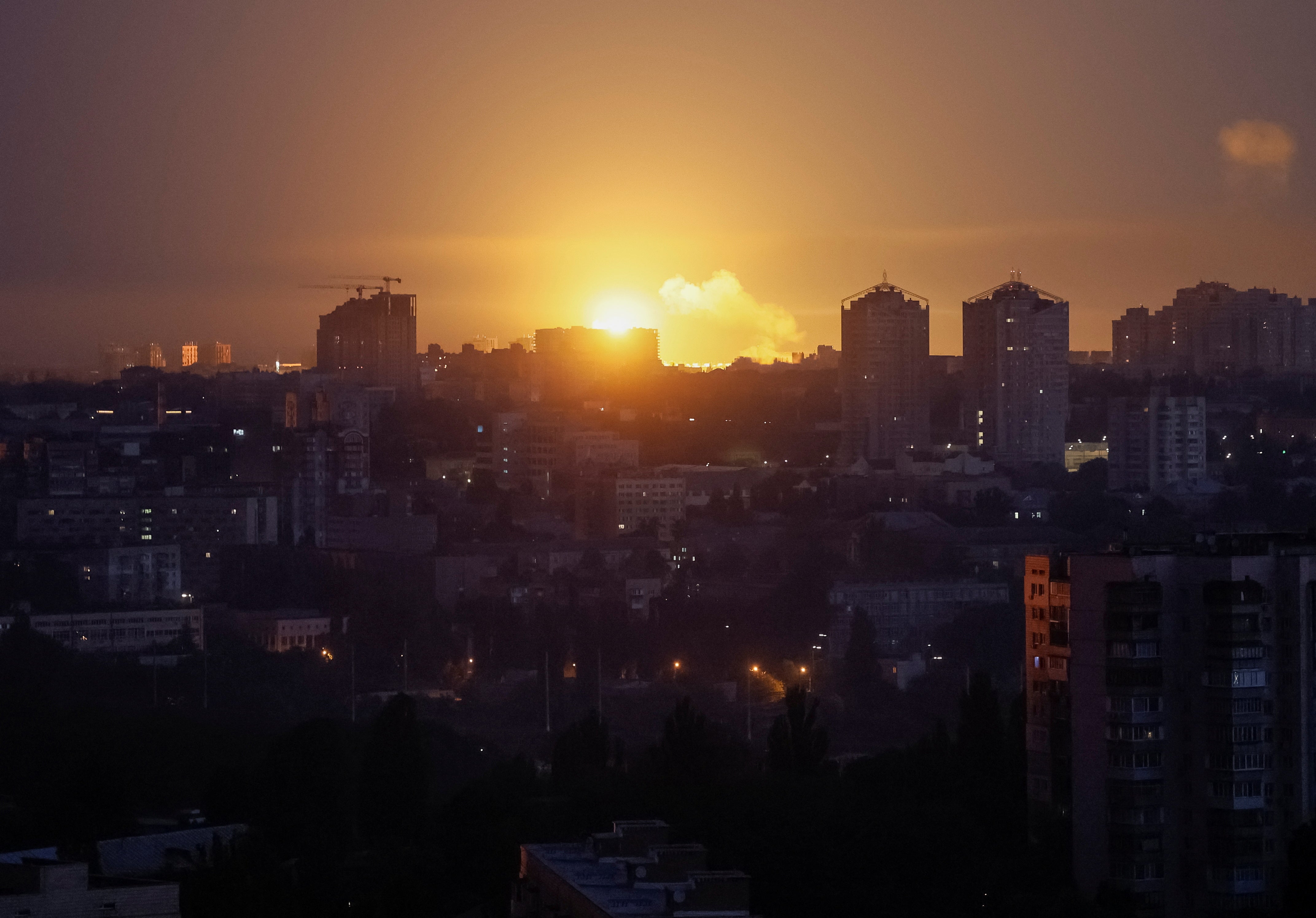 An explosion from a Russian missile lights up the sky over the city during overnight strike on Kyiv