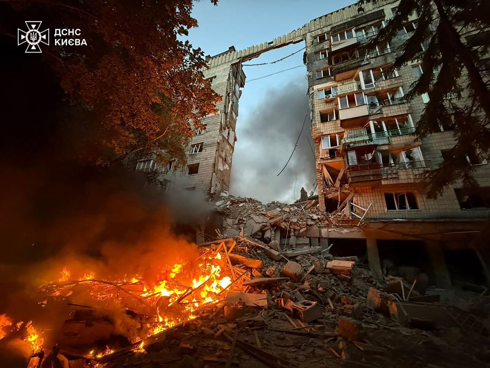Rescuers working at the site of an airstrike on a residential area in Kyiv