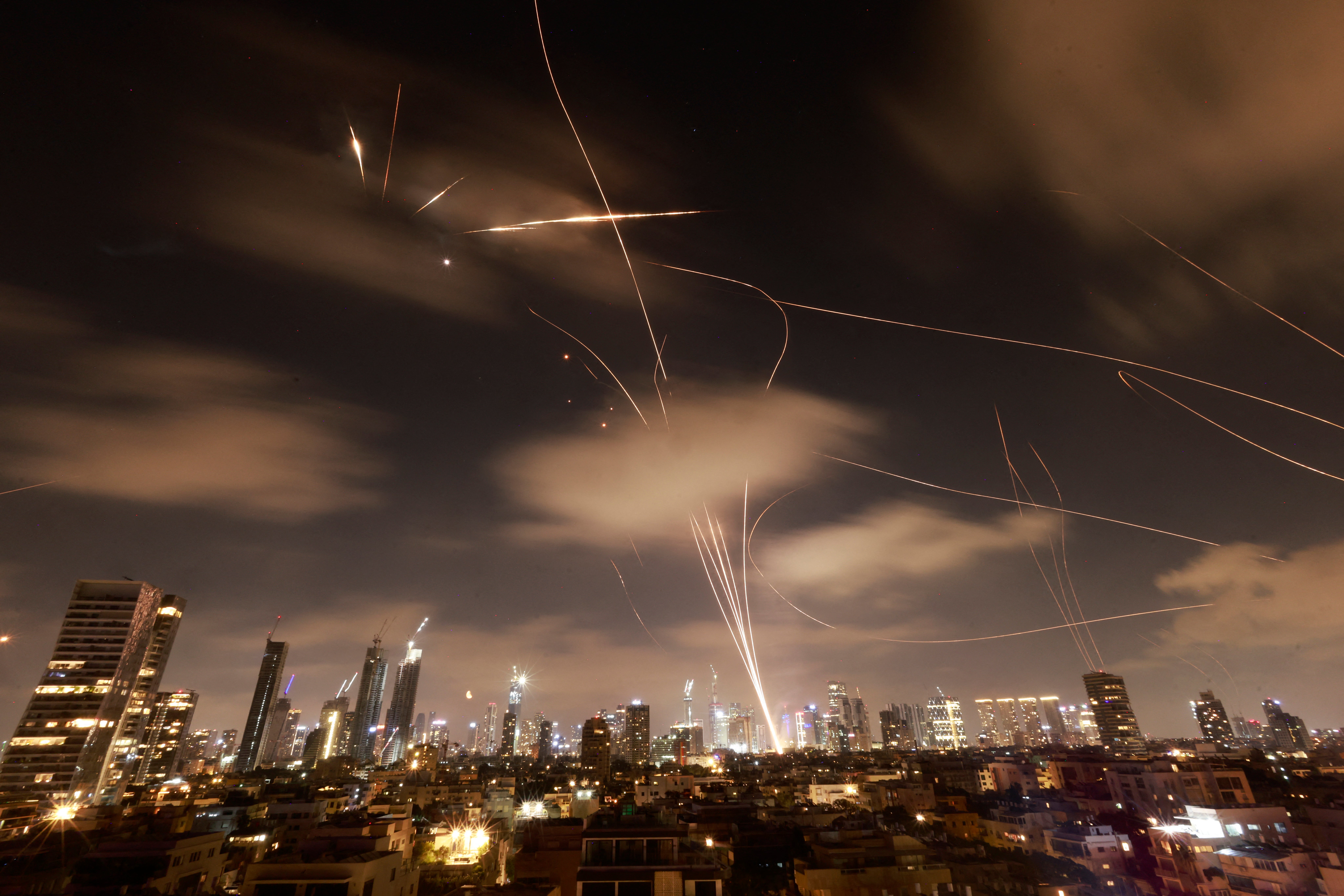 Israeli air defence systems are activated to intercept Iranian missiles over the Israeli city of Tel Aviv early on June 18, 2025