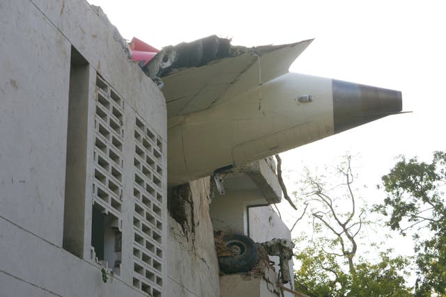 <p>The debris of an airplane sticks out of a building after it crashed in India's northwestern city of Ahmedabad in Gujarat state, Thursday, 12 June 2025</p>