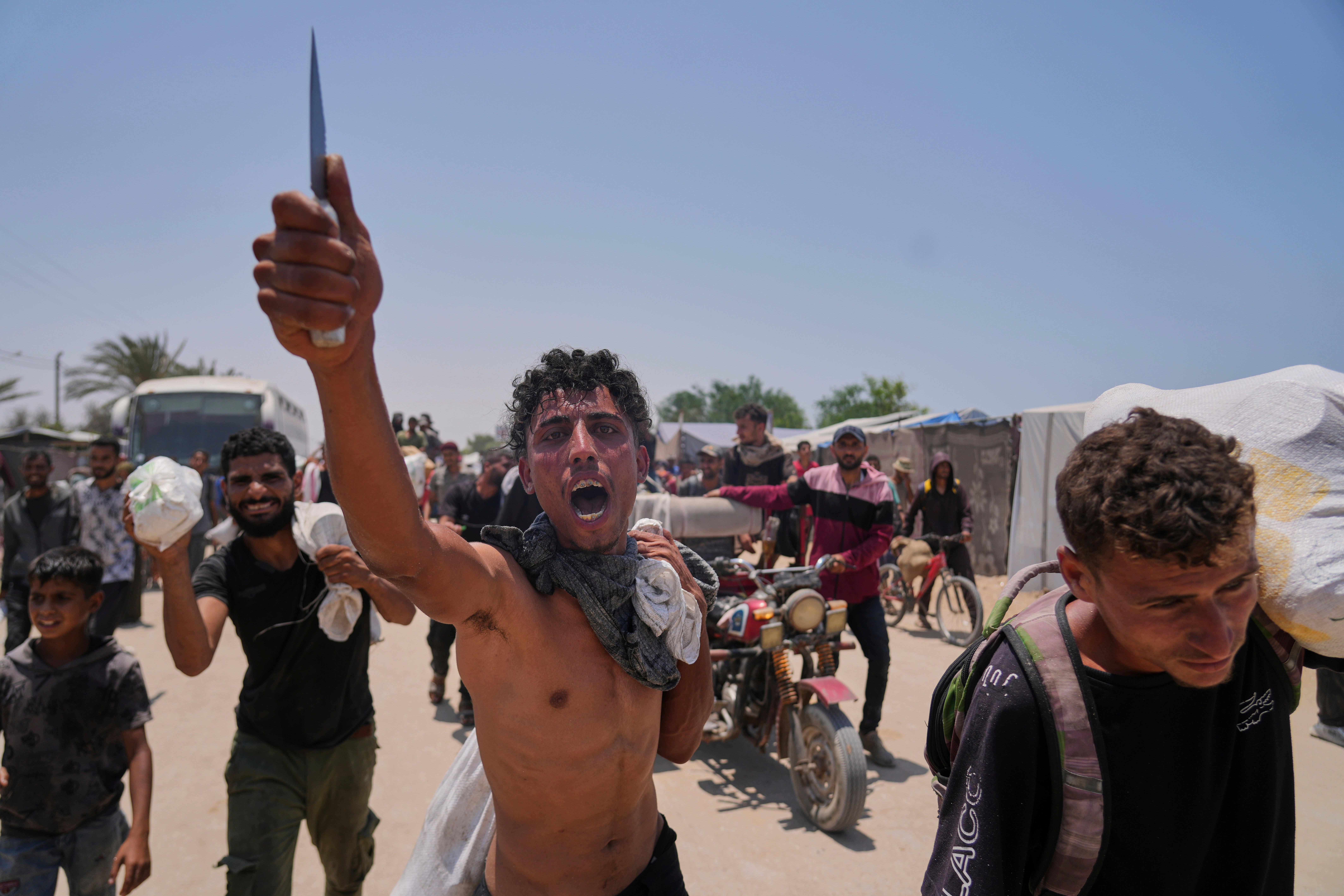 A Palestinian shouts to the camera in Arabic,