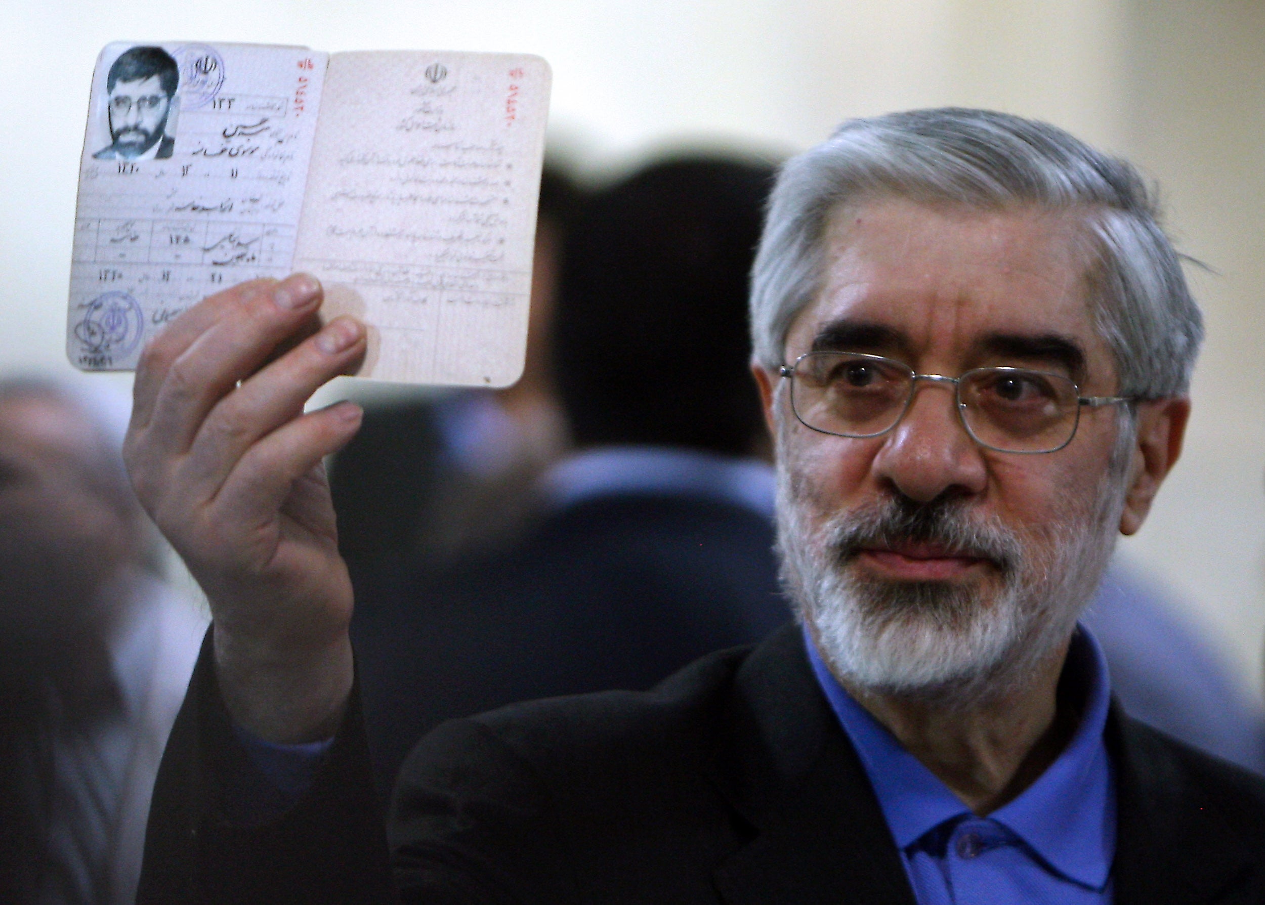 Former Iranian premier Mir Hossein Mousavi shows his identification card as he registers his candidacy for the upcoming presidential election in 2009