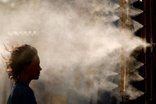 <p>Michael Mullenax, 10, from Lee's Summit, Mo., cools off in a mister at Kauffman Stadium before a baseball game between the Kansas City Royals and the Miami Marlins, June 24, 2024, in Kansas City, Mo</p>
