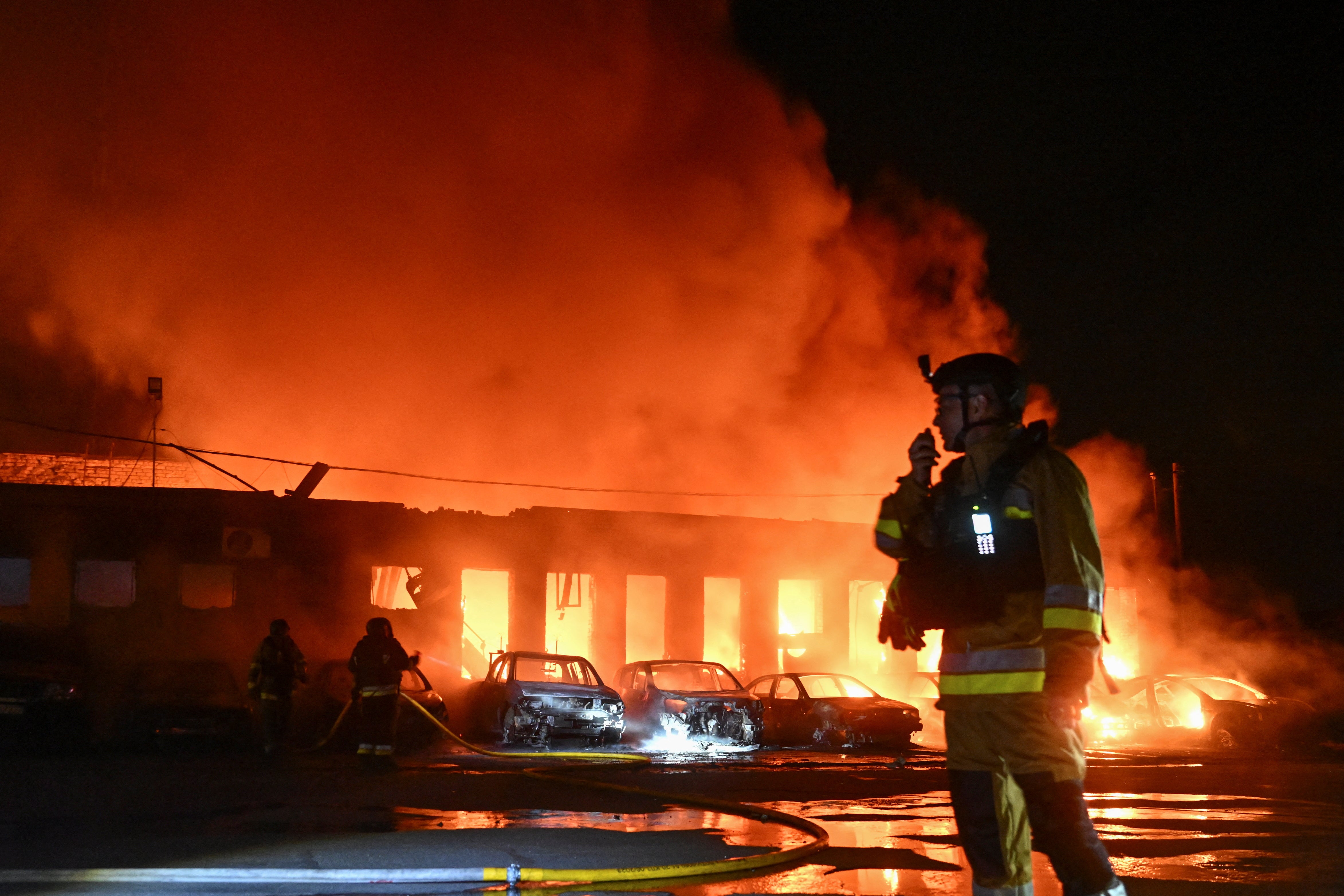 Firefighters work at the site of a private enterprise hit by a Russian drone strike, amid Russia's attack on Ukraine