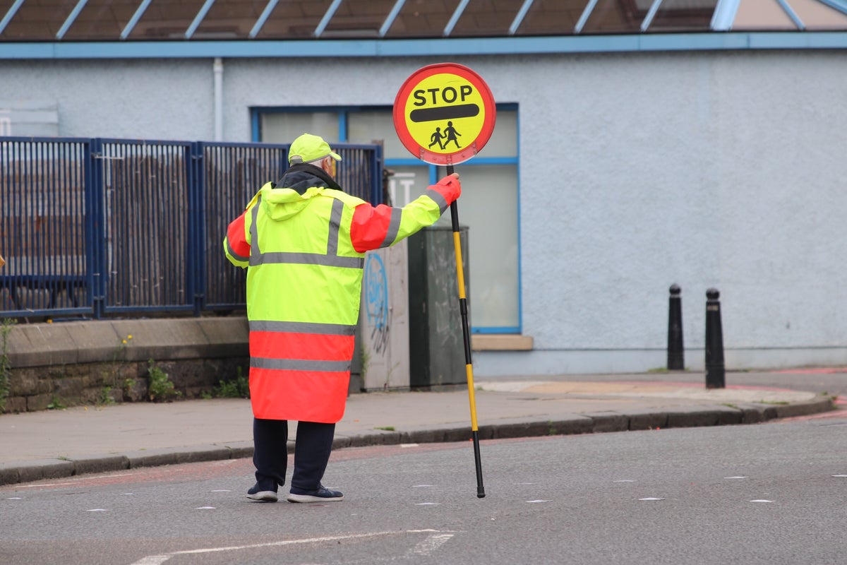 Lollipop man told to stop giving children high fives by council