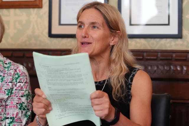 <p>MP Kim Leadbeater holds a copy of the assisted dying Bill during a press conference in Parliament (Jonathan Brady/PA)</p>