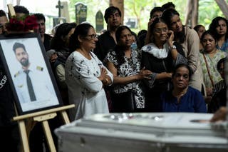 Friends and members of the family mourn near Koolot Clive Kunder, who died after the air India Boeing 787-8 Dreamliner plane crashed during take-off from Ahmedabad Airport in Ahmedabad in Mumbai