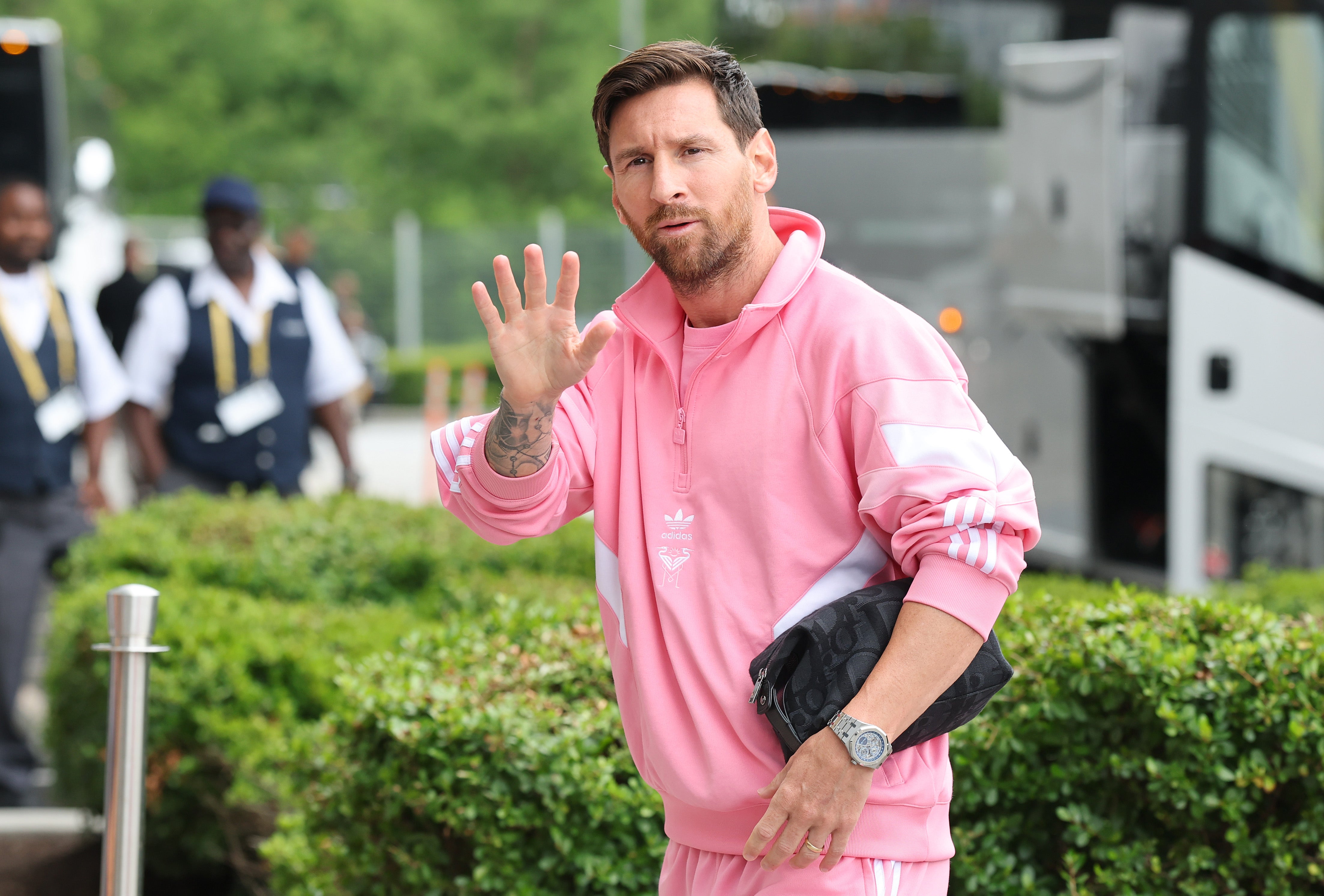 Lionel Messi waves as he arrives at the stadium
