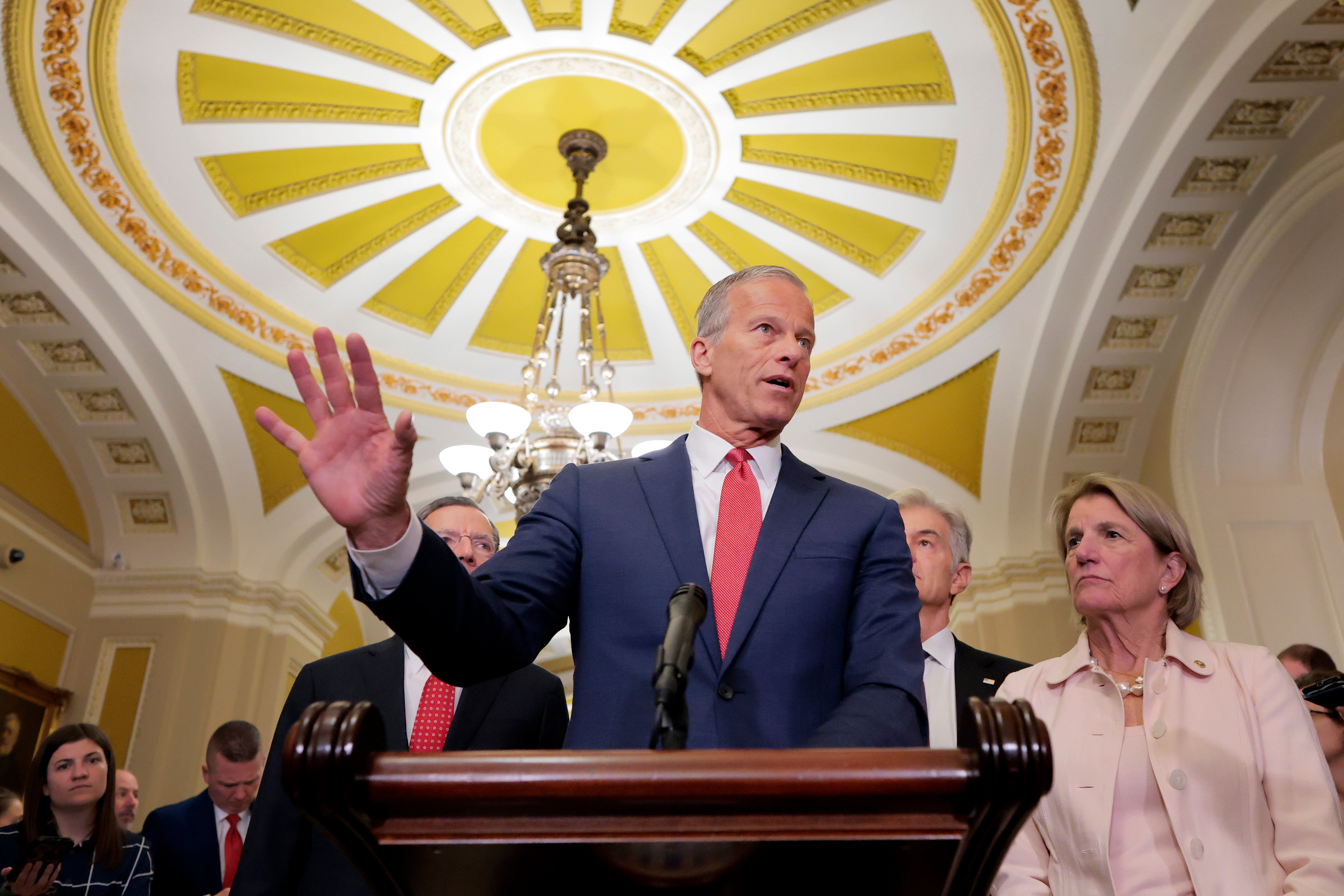 Senate Majority Leader John Thune (R-SD) speaks alongside Sen. Shelley Moore Capito (R-WV) during a news conference. Both voted for the Iraq War as members of the House of Representatives.
