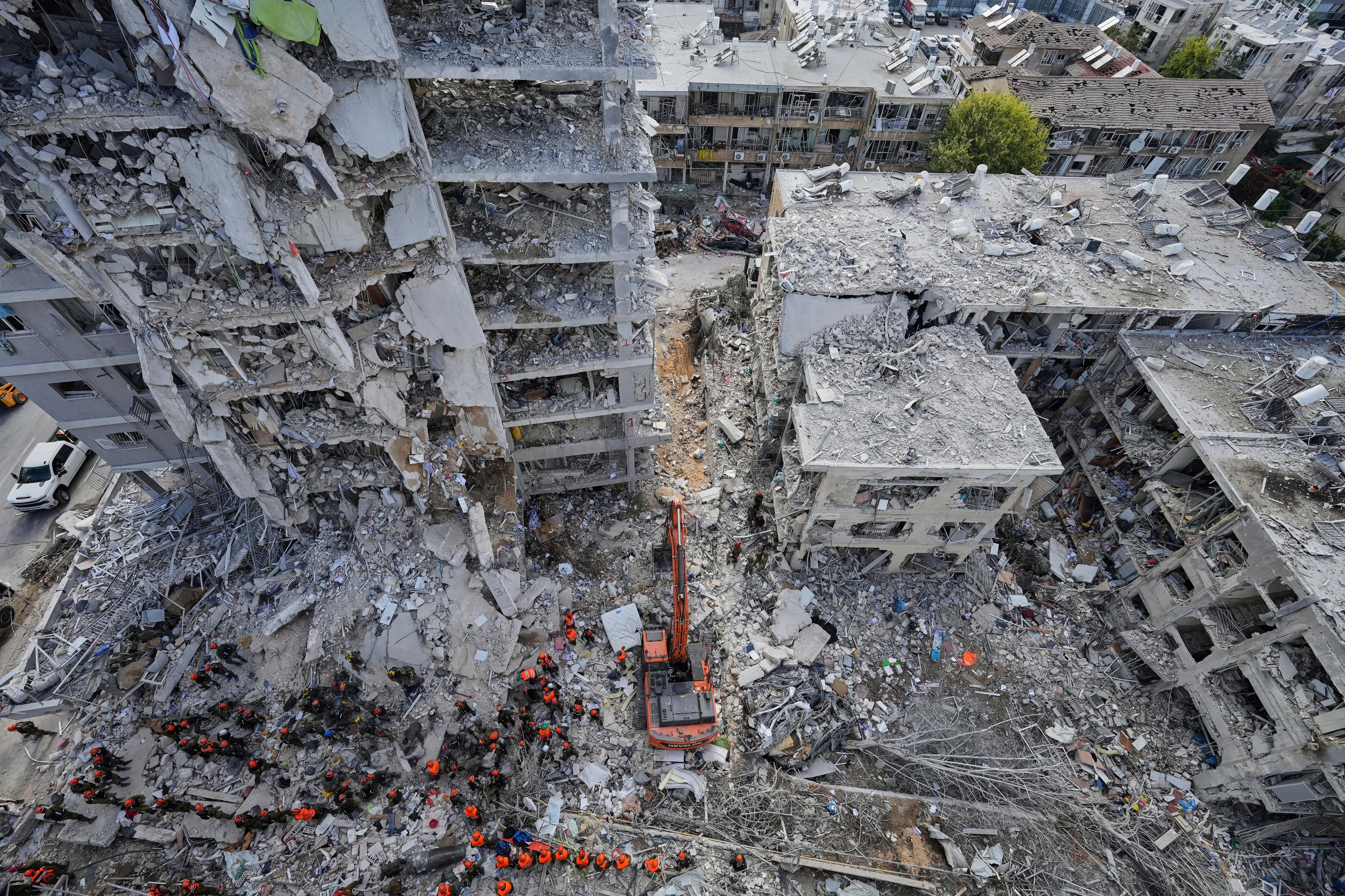 Israeli soldiers search through the rubble of residential buildings destroyed by an Iranian missile strike in Bat Yam, central Israel