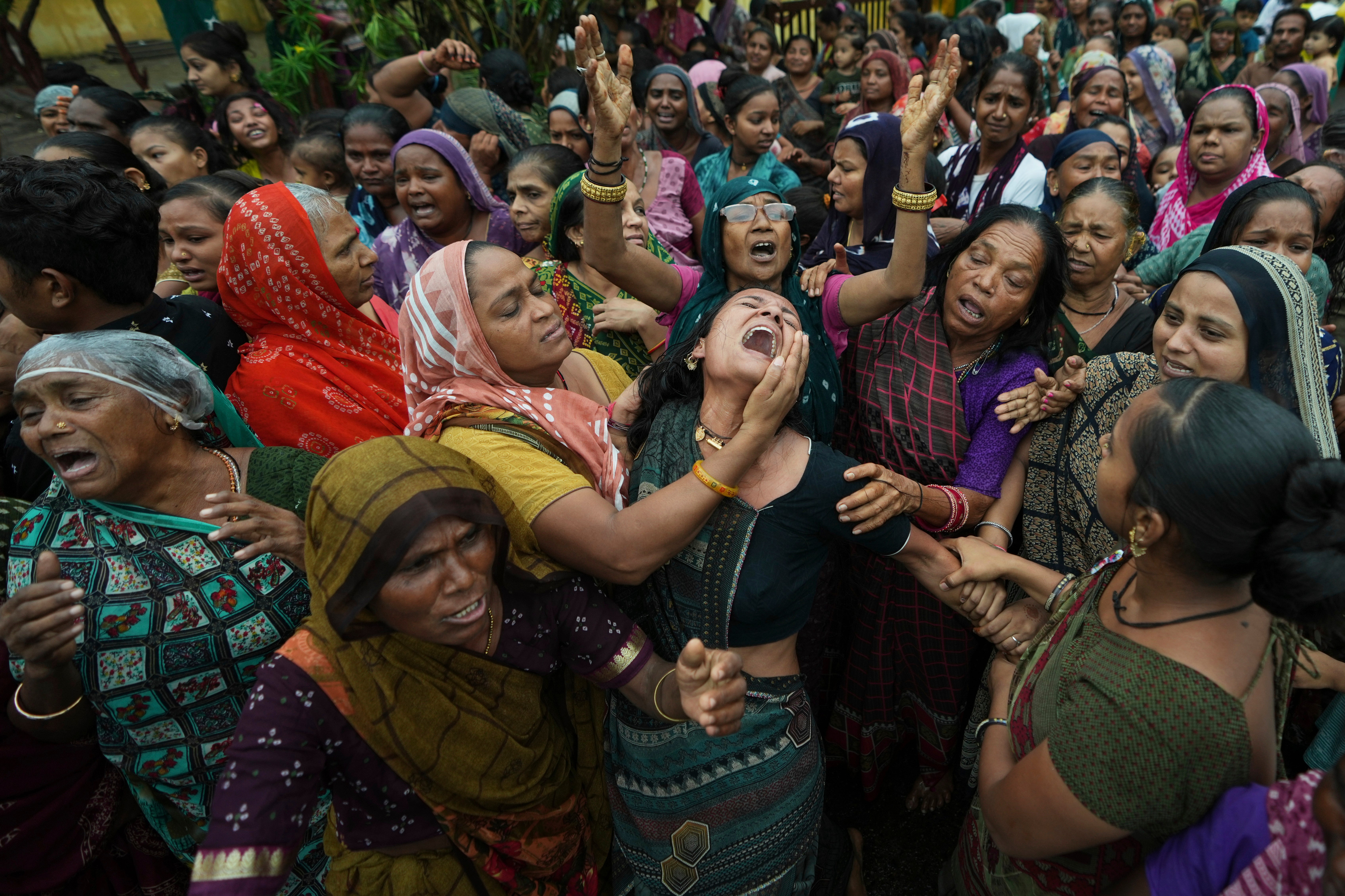 Family members and relatives of Akash Patni, victim of the Air India plane crash, grieve during his funeral procession in Ahmedabad, India