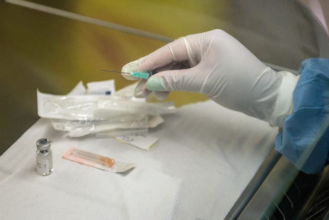 <p>Person holds an experimental vaccine against the AIDS </p>