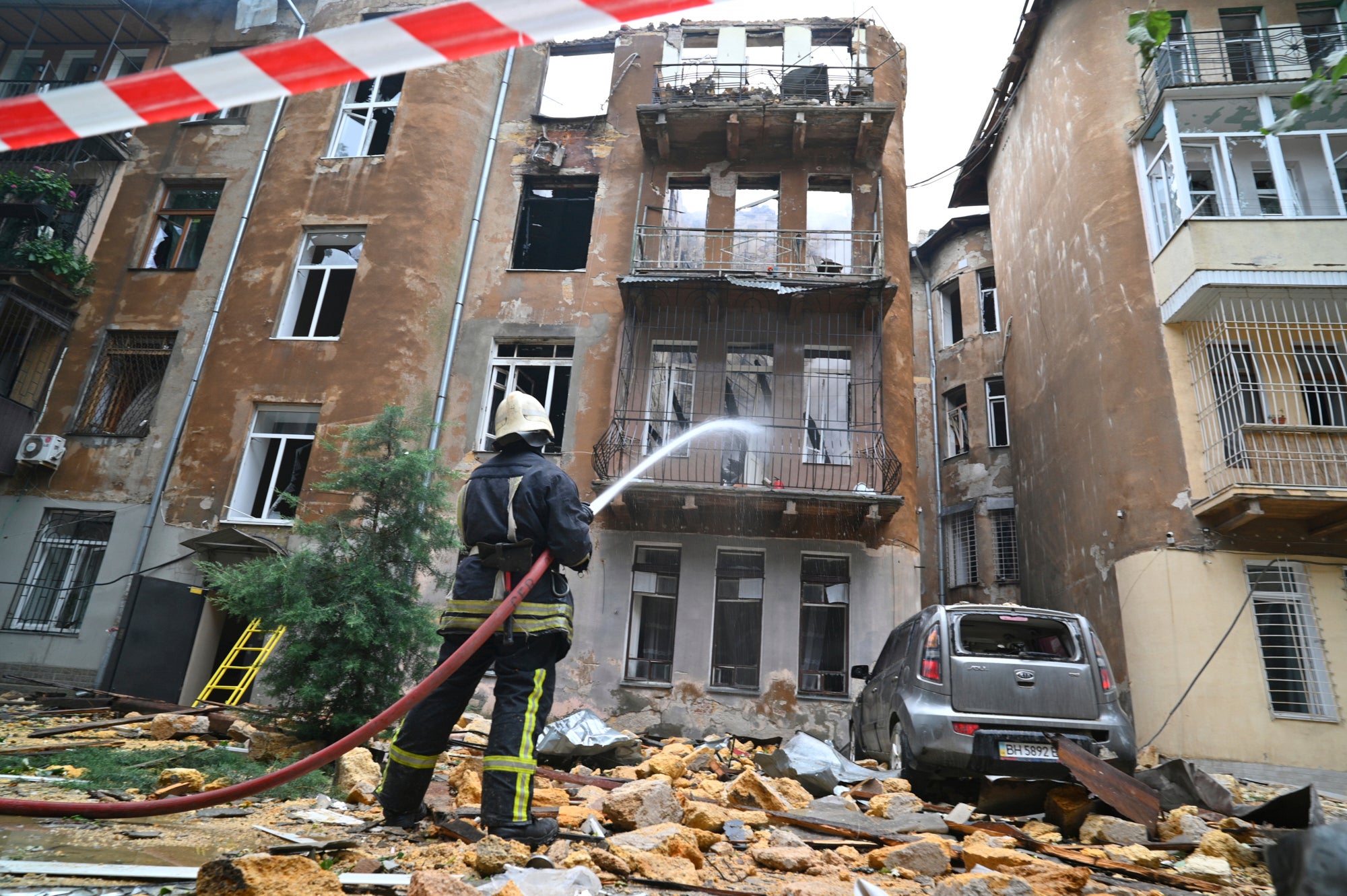 A firefighter puts out a fire in an apartment building following Russia's massive air attack in Odesa, Ukraine