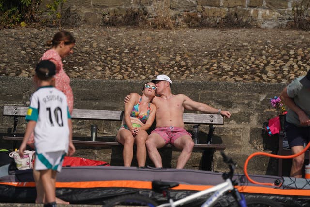 <p>People enjoy the hot weather at Cullercoats Beach in North Shields</p>
