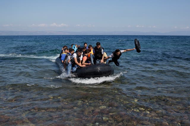 <p>Afghan migrants arrive on the shores of the Greek island of Lesbos after crossing the Aegean sea from Turkey on a inflatable dinghy, Friday, Sept. 25, 2015</p>