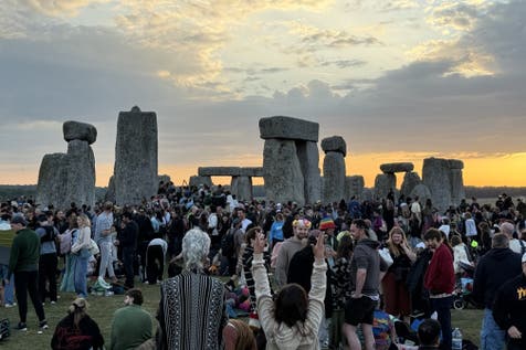 <p>People gather at Stonehenge (PA)</p>