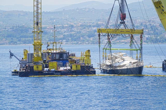 Tech tycoon Mike Lynch’s superyacht the Bayesian is lifted to the surface near the fishing town of Porticello, Sicily (Peter Byrne/PA)
