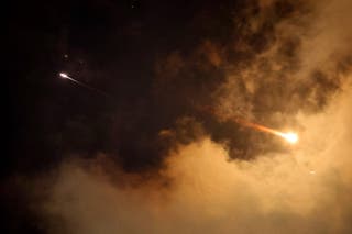 Rocket trails are seen in the sky above the Israeli coastal city of Netanya amid a fresh barrage of Iranian missile attacks on Saturday