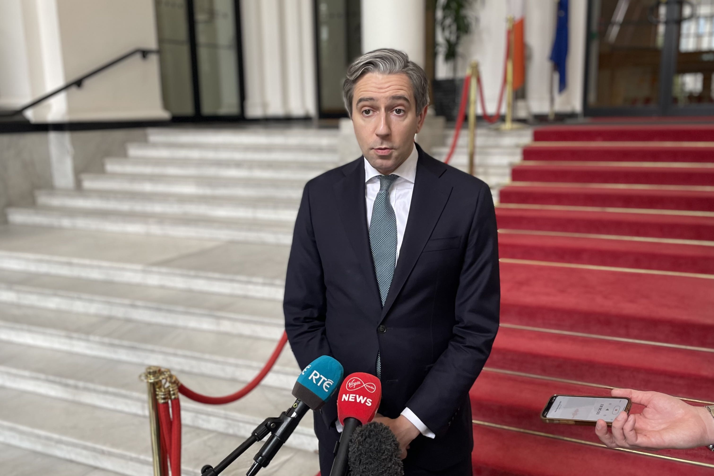 Tanaiste Simon Harris speaking to the media at Government Buildings (Grainne Ni Aodha/{PA)