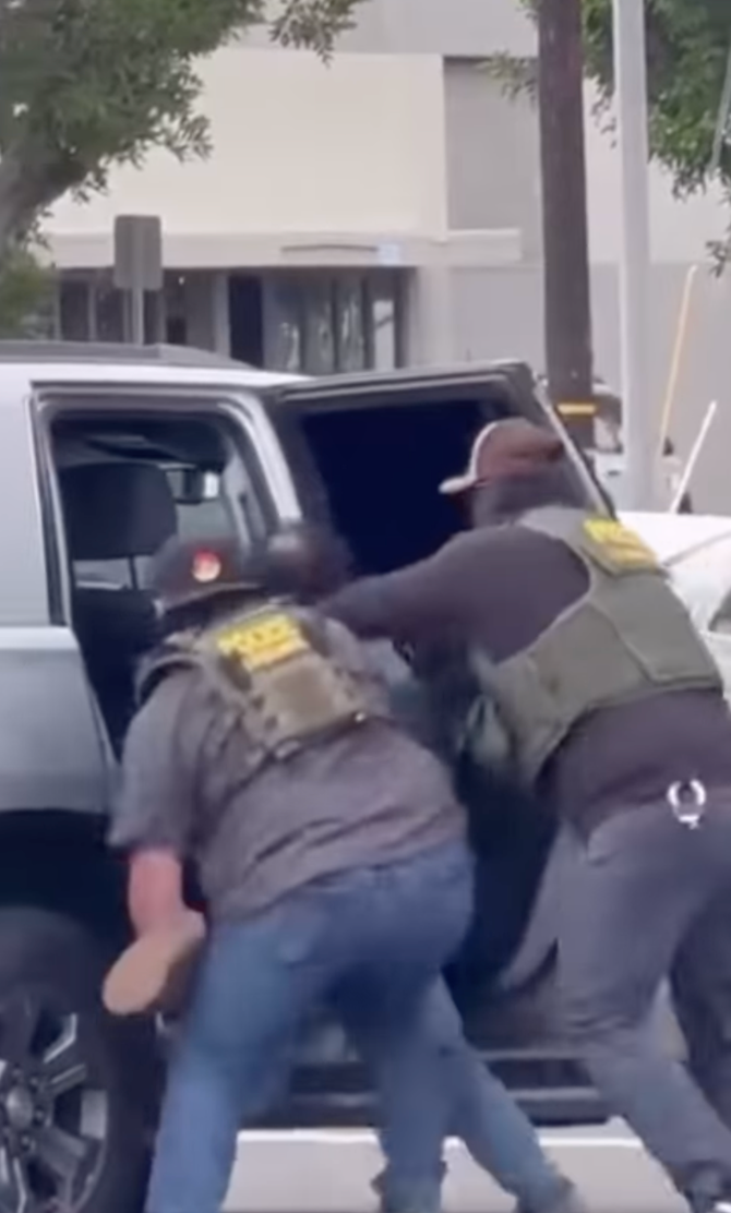The 48-year-old was bundled into the back of an unmarked SUV during the violent apprehension on Saturday