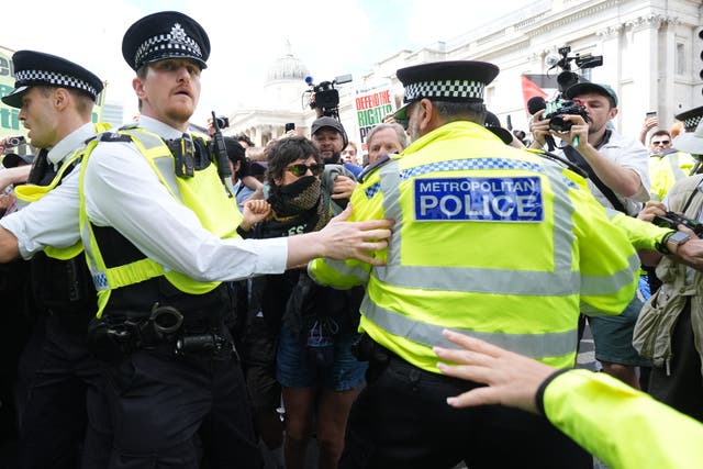 <p>Police hold protesters at bay at Trafalgar Square</p>