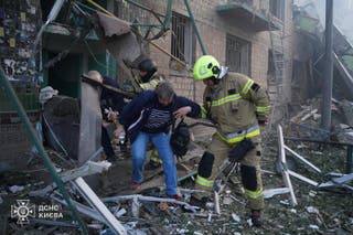 Rescuers evacuating local residents from the damaged building following night Russian drone and missile strikes in Kyiv, amid Russian invasion in Ukraine