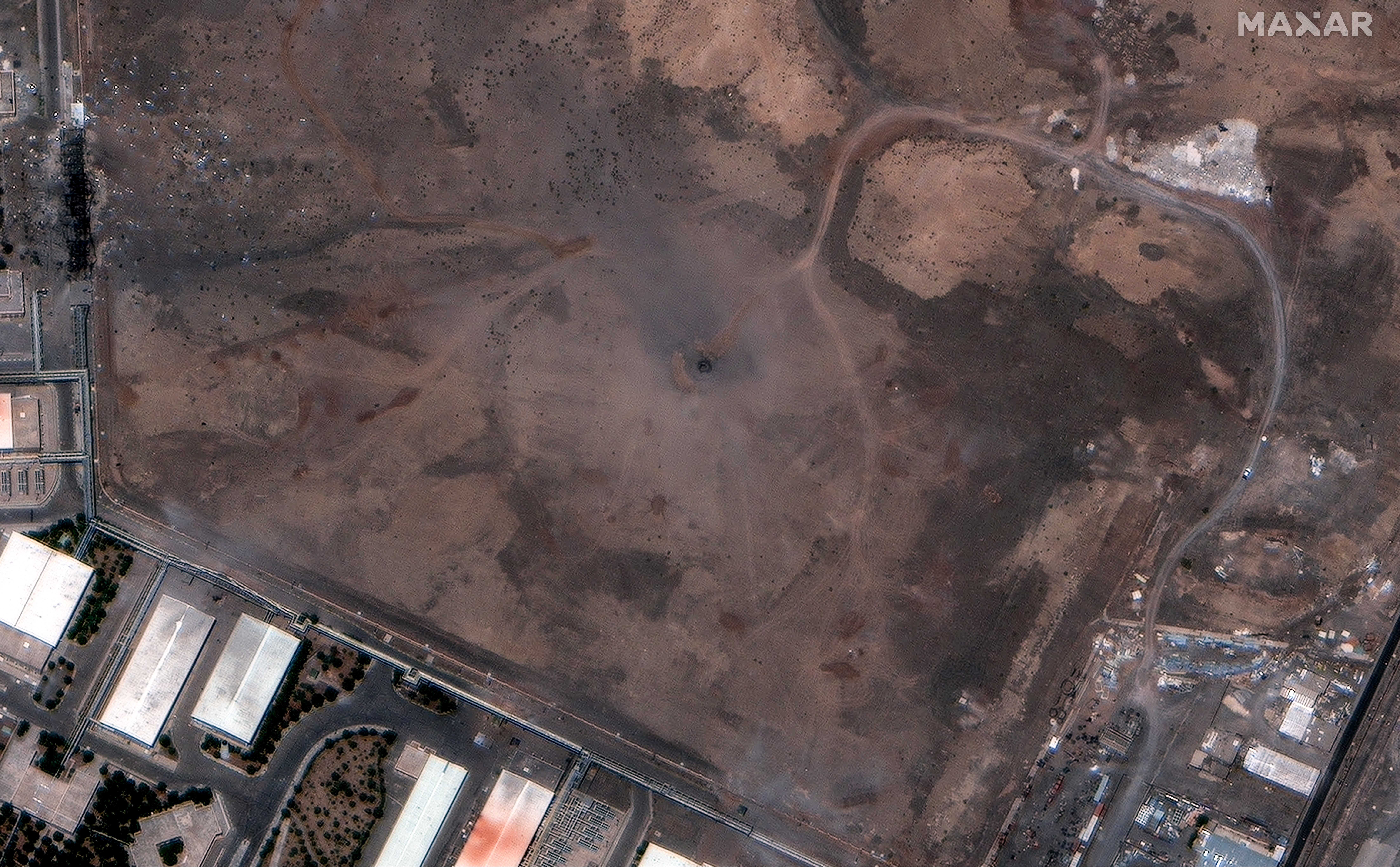 Maxar satellite image shows a crater over the underground nuclear facility at Natanz after the US attack