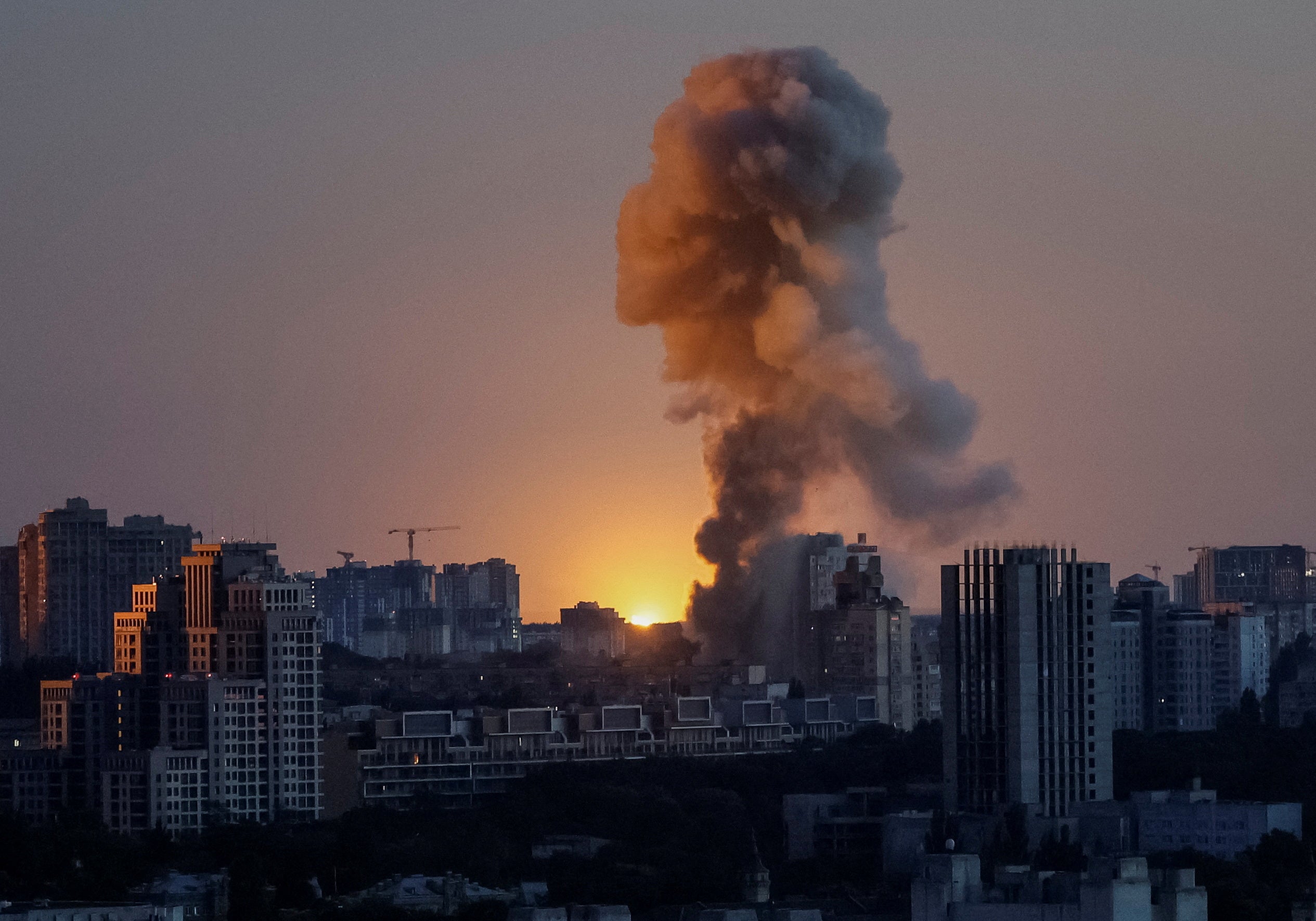 An explosion of a missile lights up the sky over the city during a Russian drone and missile strike in Kyiv, Ukraine