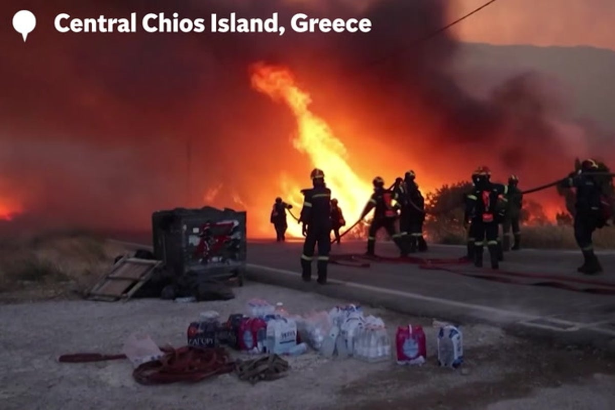 Wildfires ravage Greek holiday island as fire crews battle blazes and dozens evacuated