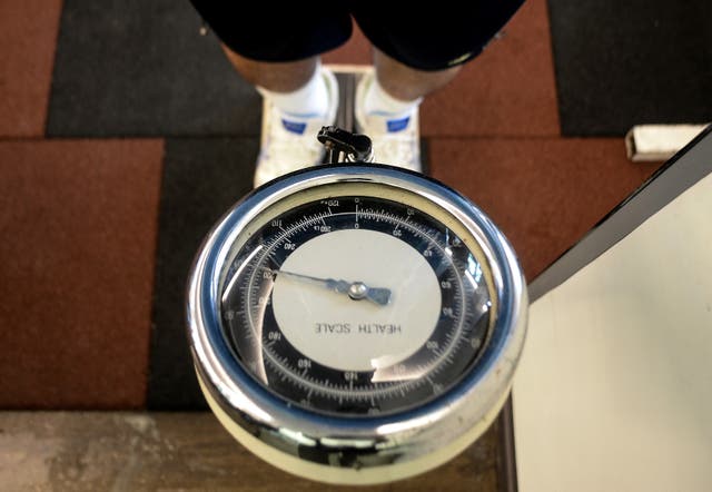 <p>Representational. Man checks his weight</p>