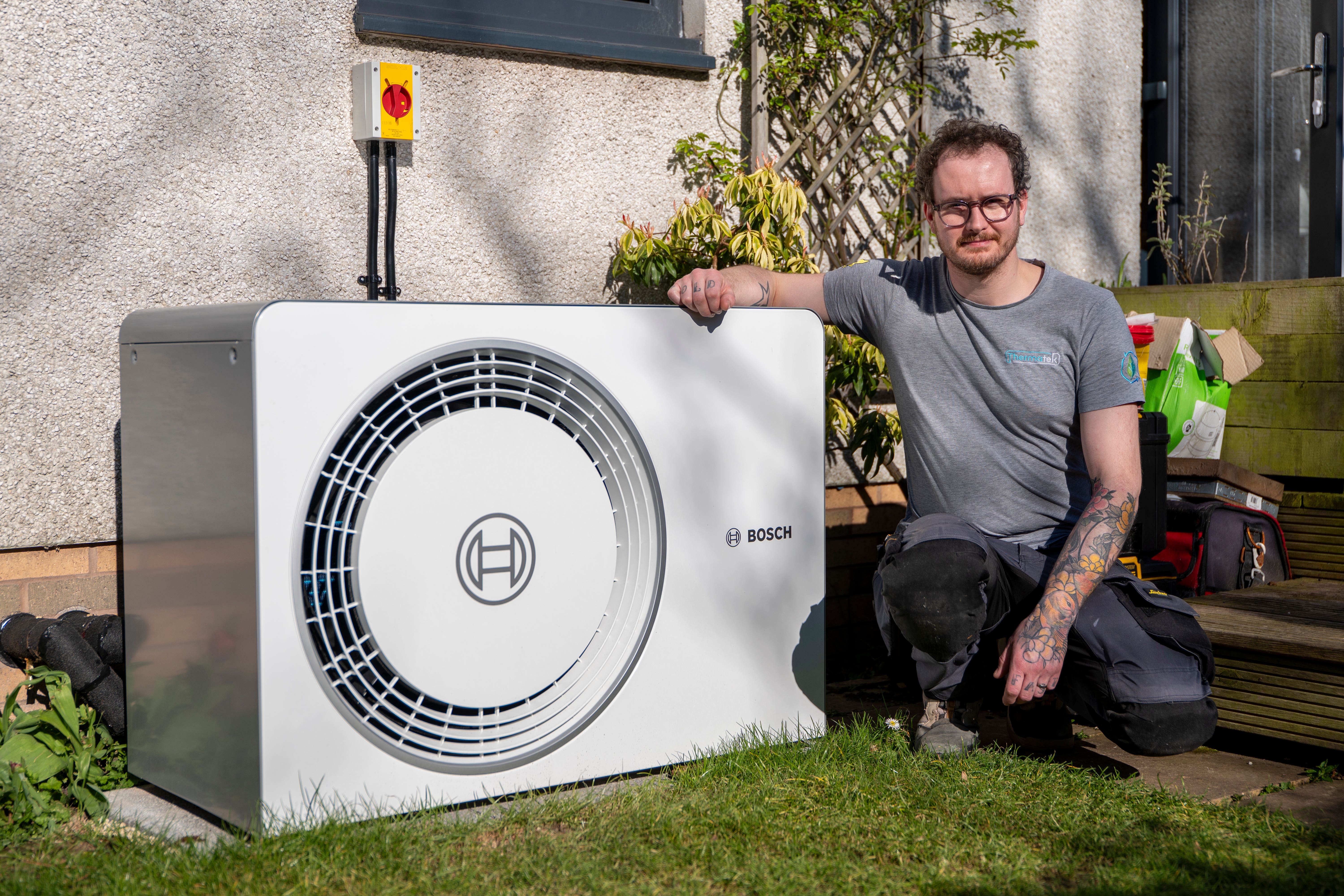 Heating engineer Ryan Beattie, a Start at Home participant, with his heat pump (Nesta/PA)