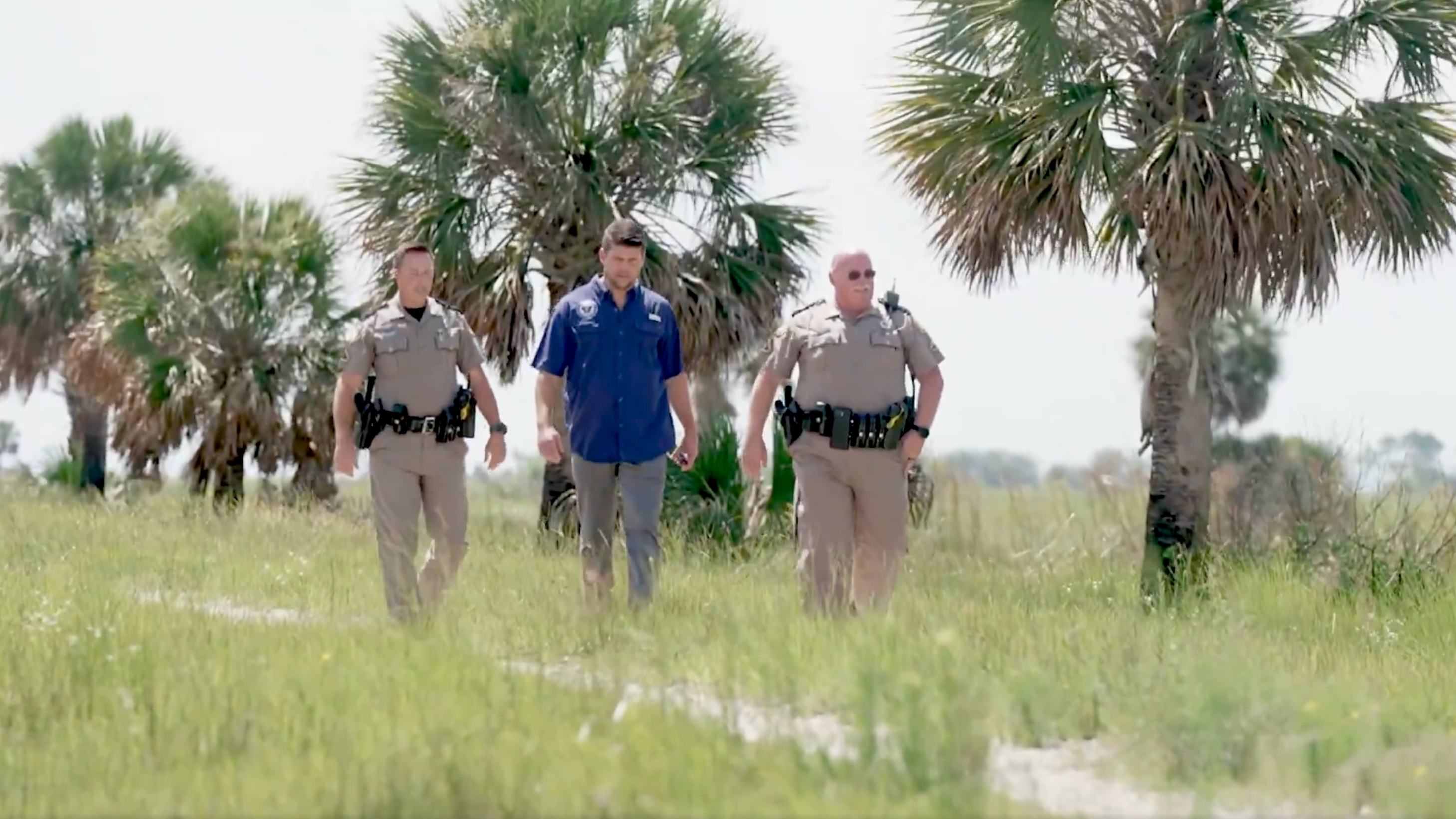 Florida Attorney General James Uthmeier inspects the 'Alligator Alcatraz' site in the Florida Everglades flanked by two police officers in a video posted to social media on June 19 2025