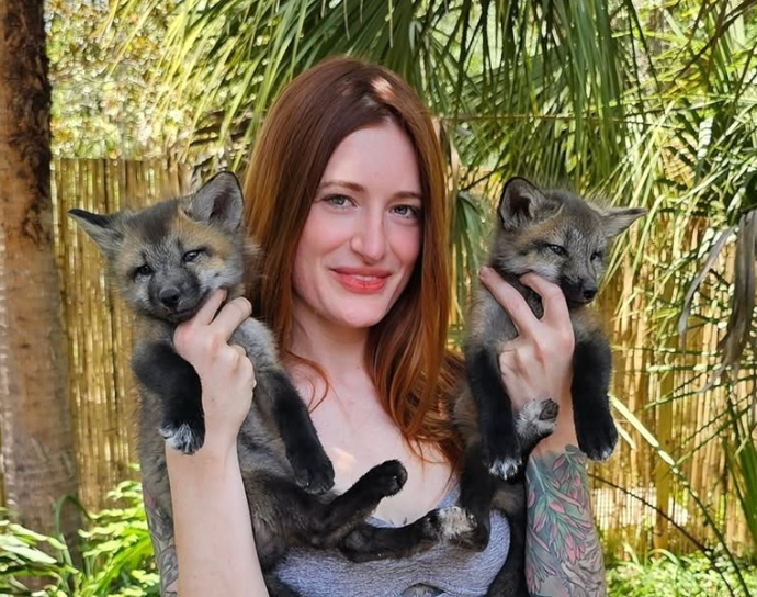 Mikayla Raines pictured with rescued foxes (Instagram via @saveafox)