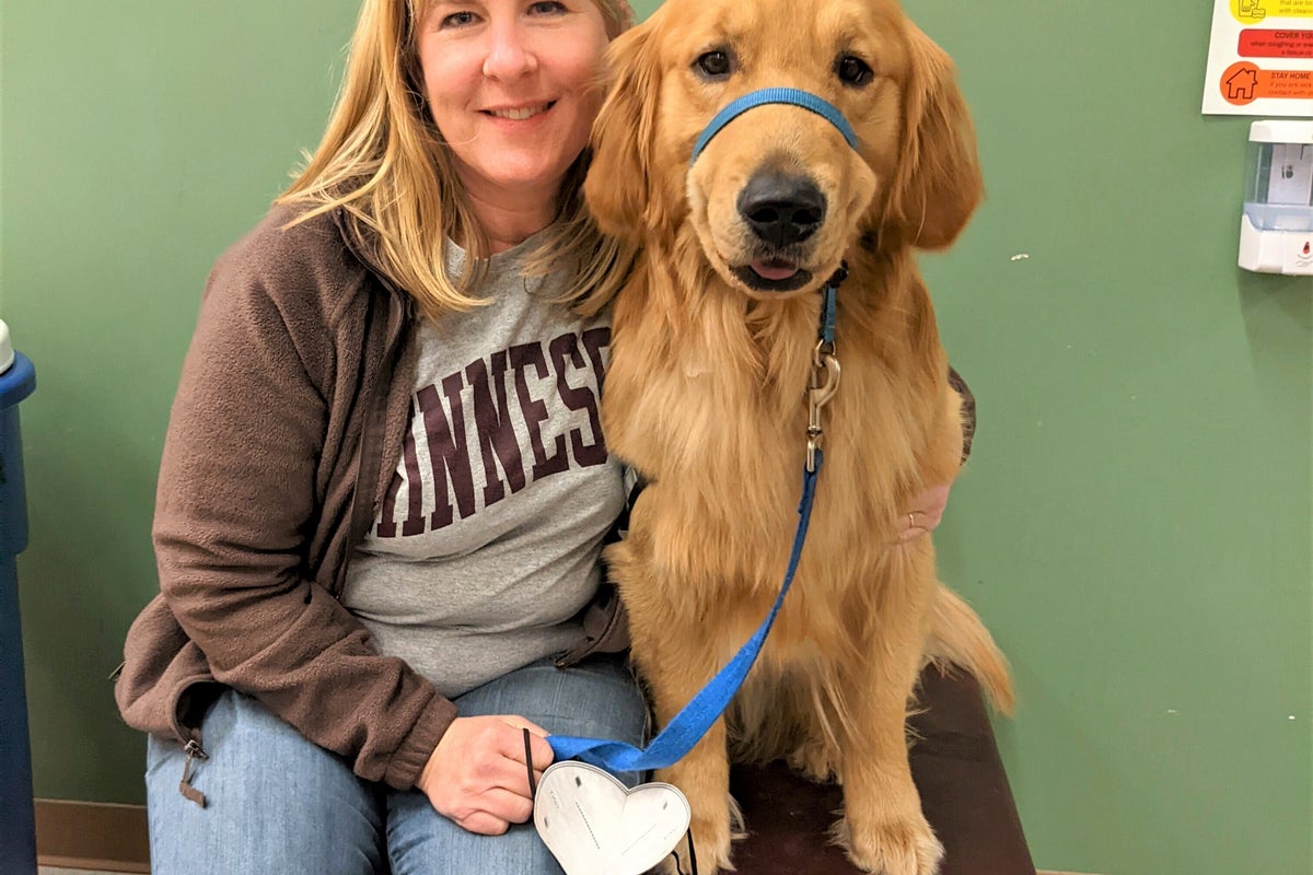 A slain Minnesota lawmaker's beloved dog, Gilbert, stays with her as she and her spouse lie in state