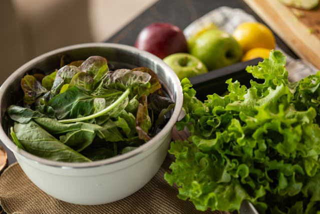 <p>Close up of fresh spinach leaves in a bowl by the organic lettuce.</p>