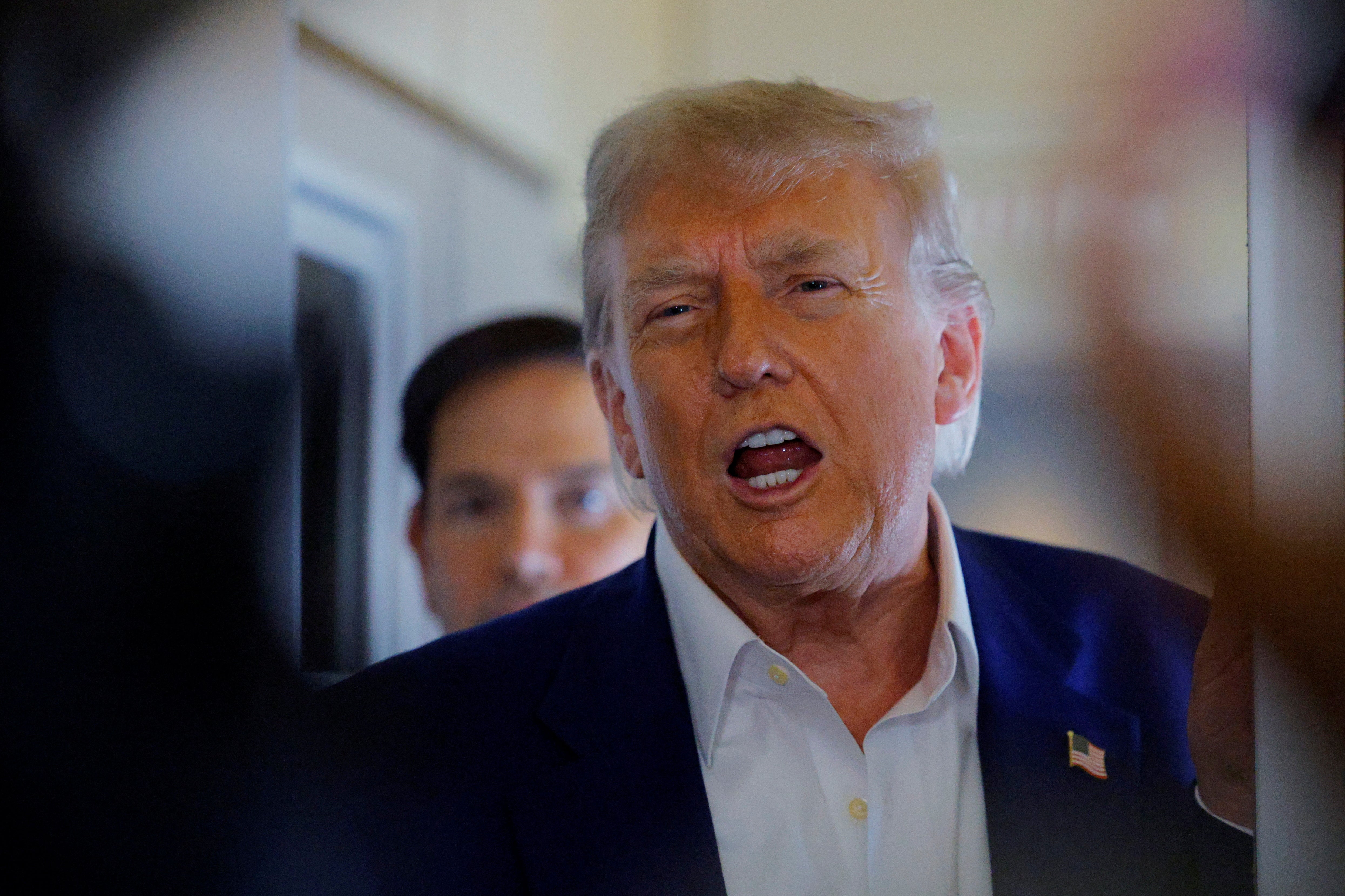 President Donald Trump speaks to reporters onboard Air Force One after blasting Israel and Iran for failing to accede to ceasefire he’d announced the night before.