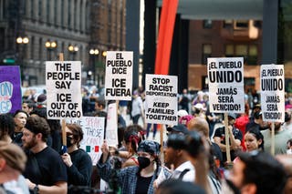 A woman has been charged after police say she drove through a crowd of demonstrators protesting against Immigration and Customs Enforcement raids in Chicago
