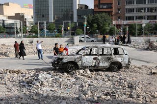 An ambulance burned by Israeli attacks stands on a street in Tehran