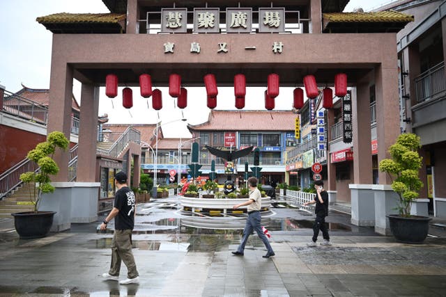 <p>File. People walk at a recreation of a Taiwanese village in Kunshan in China's Jiangsu province on 10 June 2025</p>
