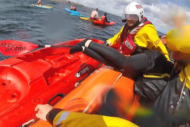 Lifeboat crews and lifeguards rescue some of the 18 people from the sea after they were blown offshore (RNLI/PA)