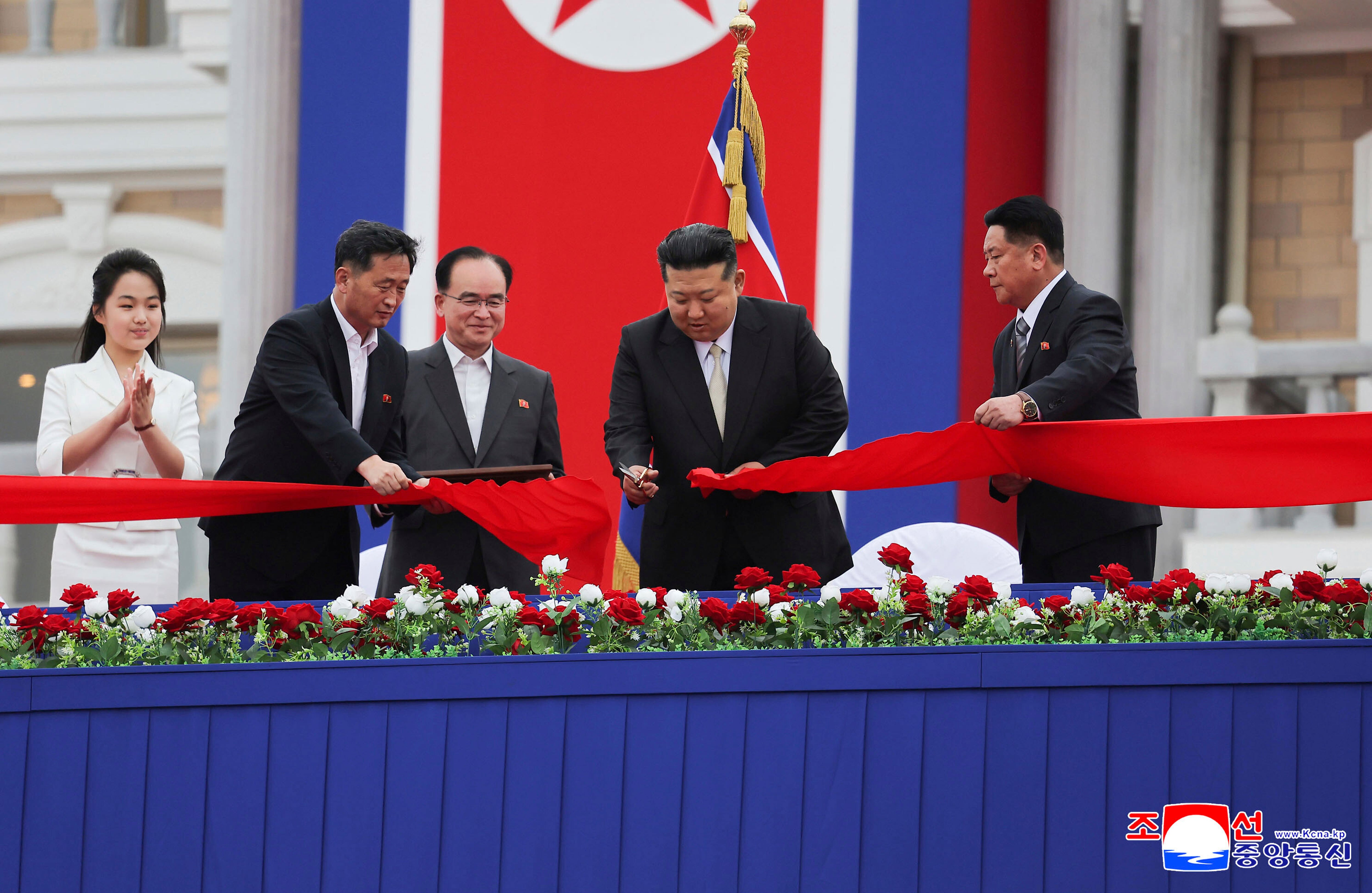 In this photo provided by the North Korean government, North Korean leader Kim Jong Un, second right, with his daughter, left, cuts the inaugural tape during a completion ceremony of the Wonsan-Kalma coastal tourist zone in North Korea Tuesday, June 24, 2025