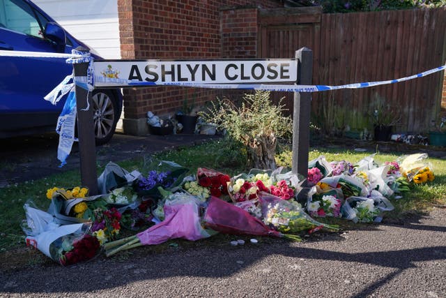 Floral tributes near to the scene in Ashlyn Close, Bushey, Hertfordshire, where Carol Hunt, the wife of BBC Five Live racing commentator John Hunt, and two of their daughters, Hannah, 28, and Louise, 25, were killed (Jonathan Brady/PA)