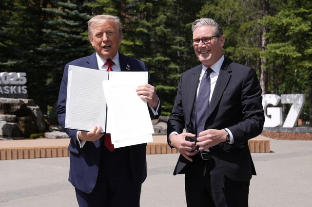 <p>US President Donald Trump (left) holding a UK-US trade deal with Prime Minister Sir Keir Starmer (Stefan Rousseau/PA)</p>
