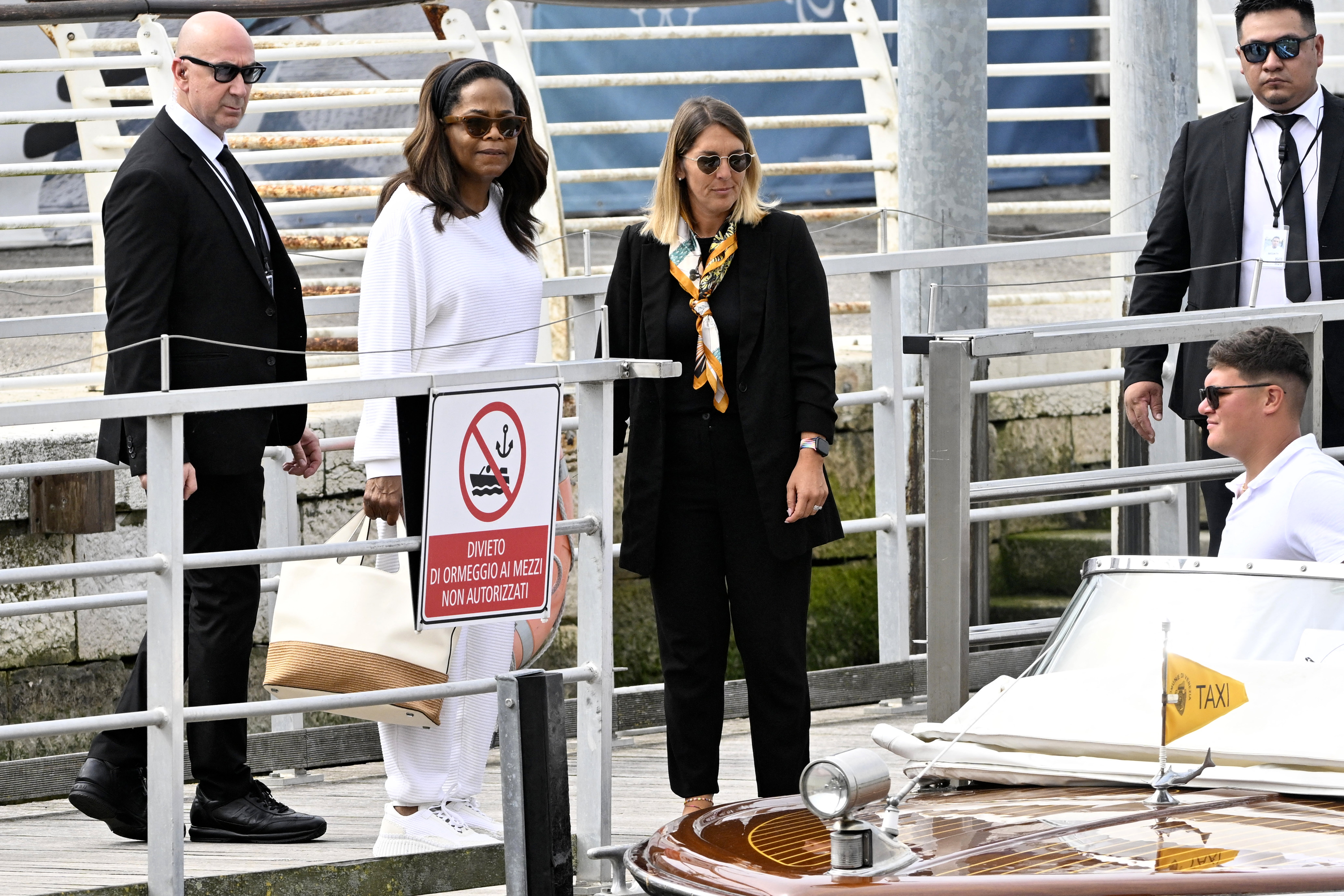 Oprah Winfrey prepares to board a taxi boat at Venice Marco Polo airport